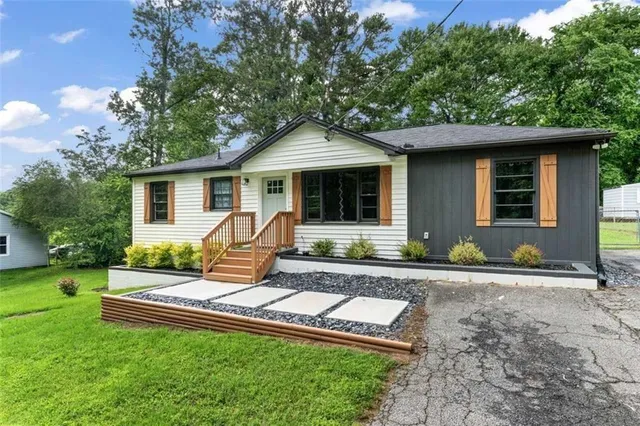 a front view of house with yard outdoor seating and green space