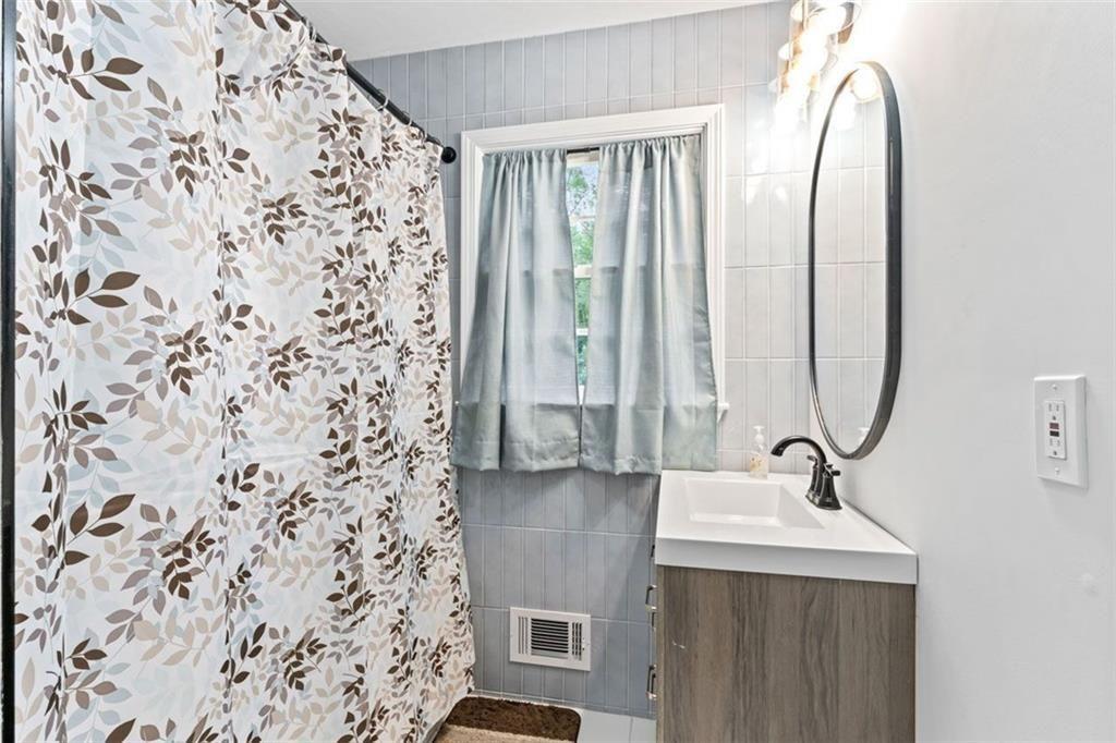 1326 Stella Circle Southwest Mableton, GA 30126 - Photo 21 of 26 a bathroom with a sink and a mirror