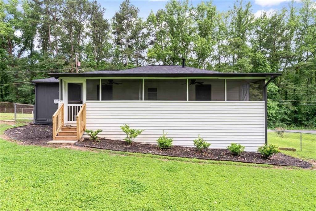 1326 Stella Circle Southwest Mableton, GA 30126 - Photo 25 of 26 a front view of a house with a yard