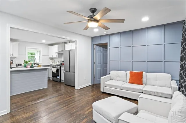 a living room with furniture and kitchen view