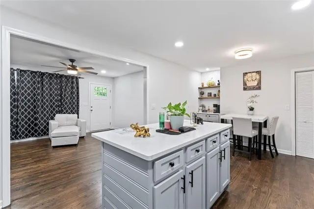 a kitchen that has a table and chairs in it