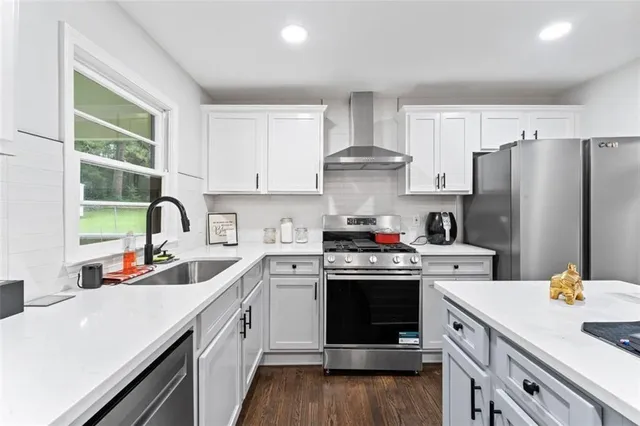 a kitchen with stainless steel appliances a sink stove and refrigerator