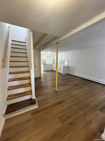 a view of a room with wooden floor