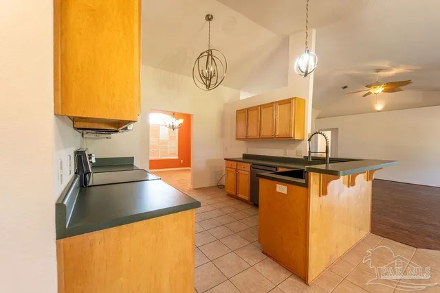 a kitchen with stainless steel appliances granite countertop a sink and a stove