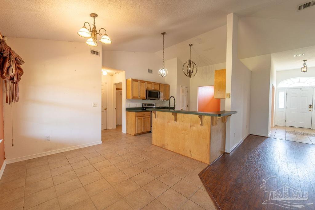 4907 Chads Circle Pace, FL 32571 - Photo 13 of 40 a view of a kitchen with a sink and a refrigerator