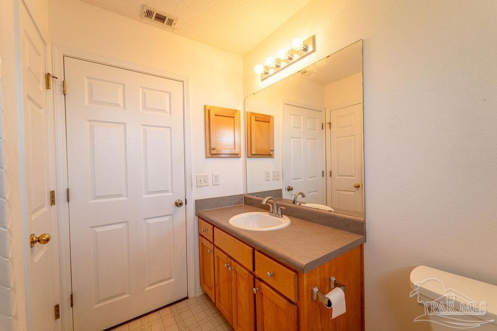 4907 Chads Circle Pace, FL 32571 - Photo 17 of 40 a bathroom with a sink and a mirror