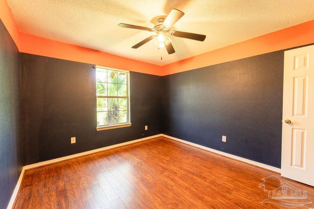 4907 Chads Circle Pace, FL 32571 - Photo 18 of 40 a view of a big room with windows and chandelier fan