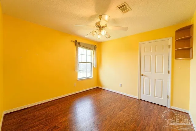 a view of livingroom with window ceiling fan and hardwood floor