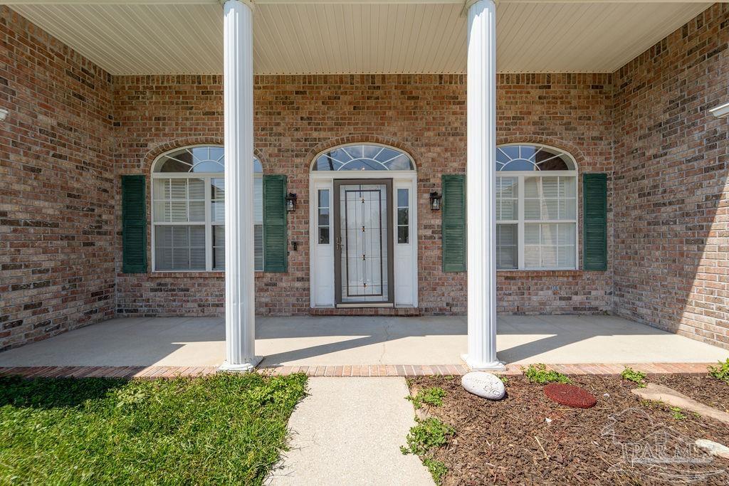 4907 Chads Circle Pace, FL 32571 - Photo 2 of 40 a view of a brick house with many windows