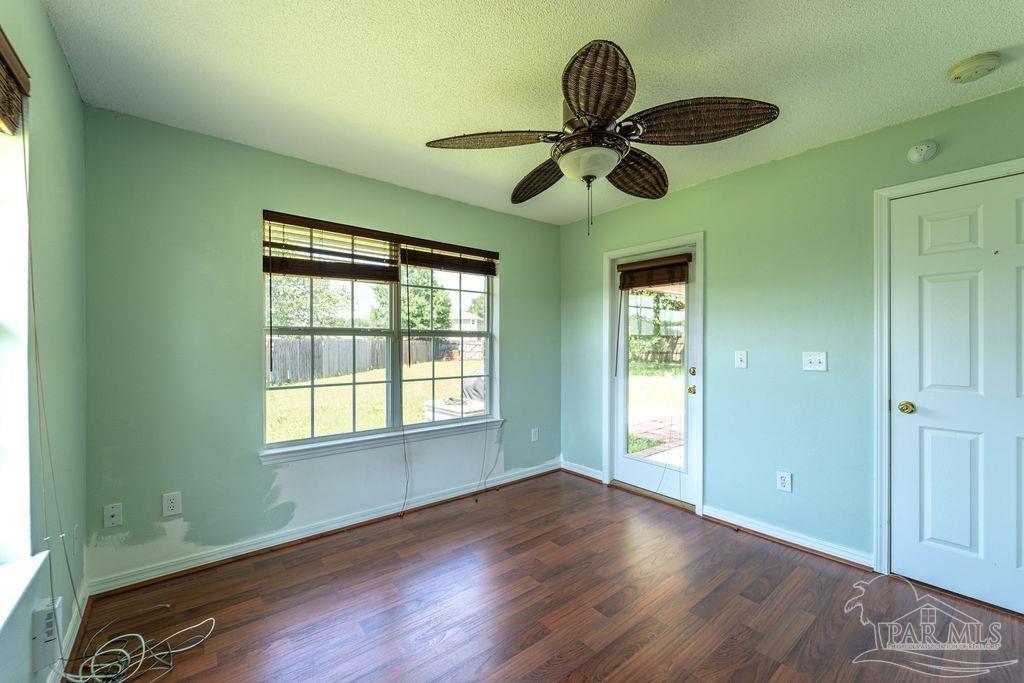 4907 Chads Circle Pace, FL 32571 - Photo 23 of 40 a view of an empty room with wooden floor and window