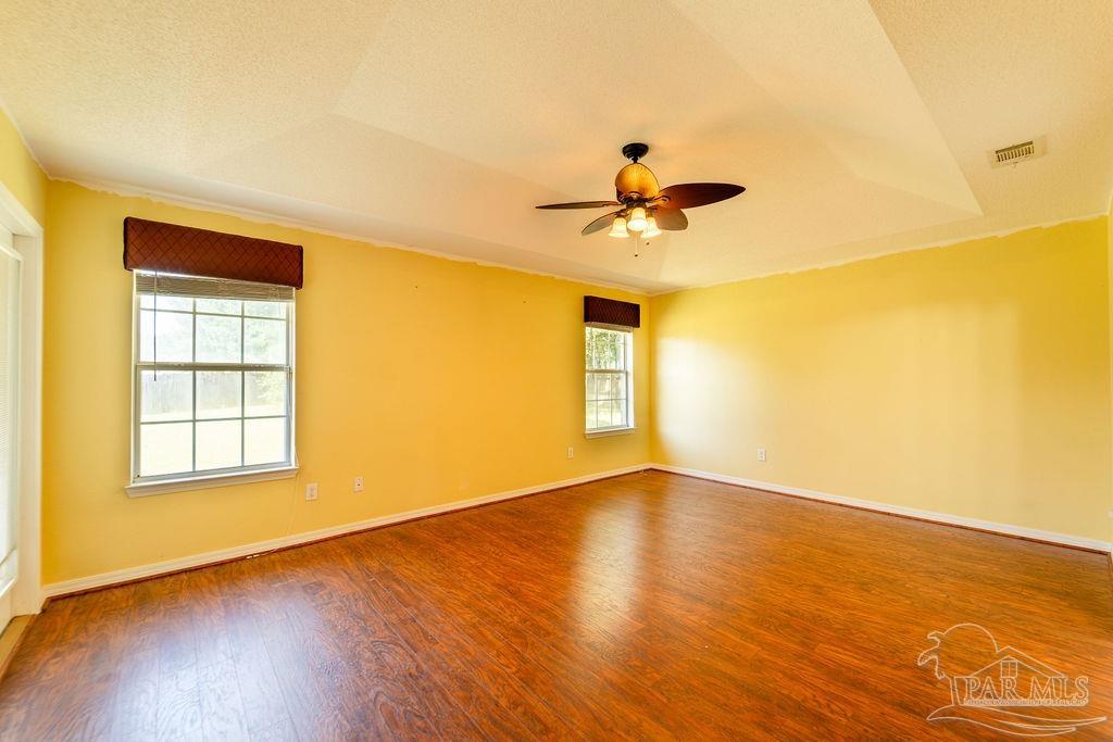 4907 Chads Circle Pace, FL 32571 - Photo 25 of 40 a view of an empty room with wooden floor and a window