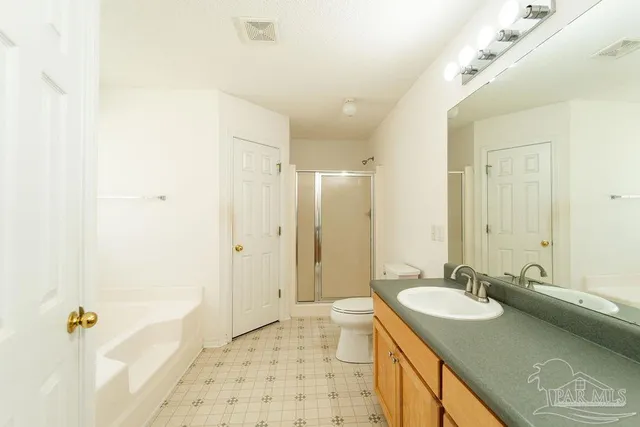 a bathroom with a granite countertop sink a mirror a shower and a bathtub