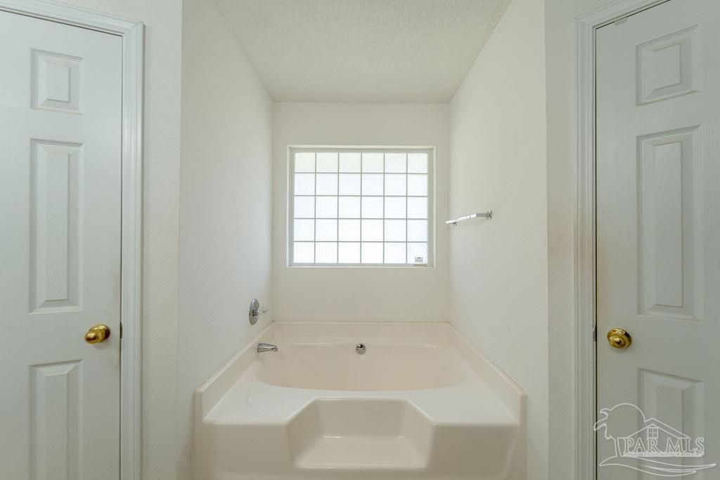 4907 Chads Circle Pace, FL 32571 - Photo 32 of 40 a bathroom with a bathtub