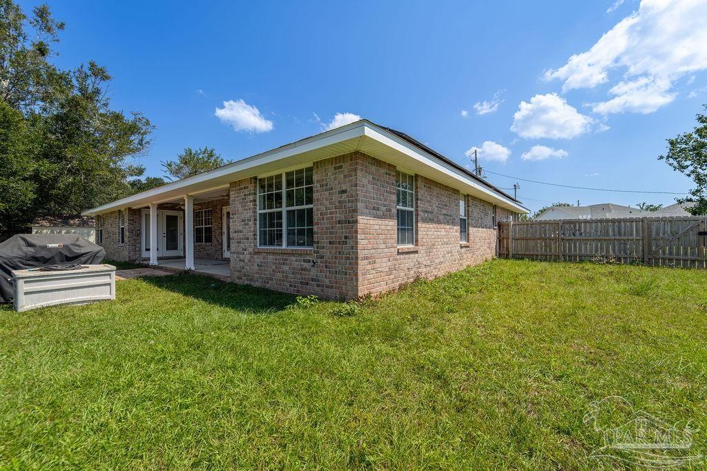 4907 Chads Circle Pace, FL 32571 - Photo 38 of 40 a view of a house with backyard and sitting area