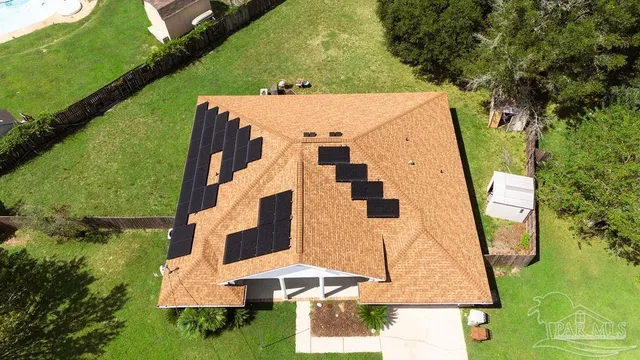 an aerial view of a house with a yard