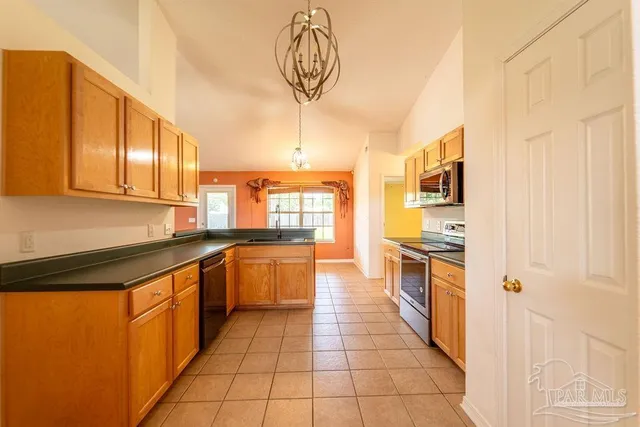 a large kitchen with stainless steel appliances granite countertop a sink and cabinets