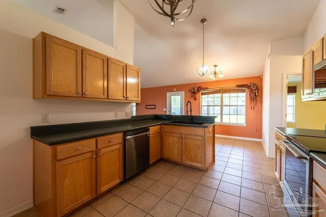 a kitchen with stainless steel appliances granite countertop a sink and cabinets