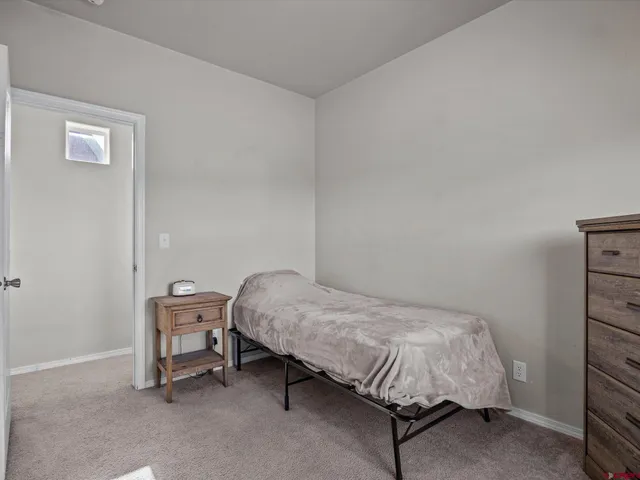 a bedroom with a bed and a chair in it