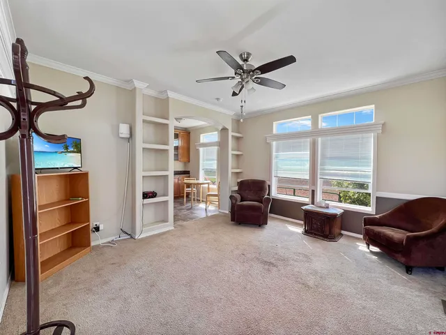 a living room with furniture cabinets and a window