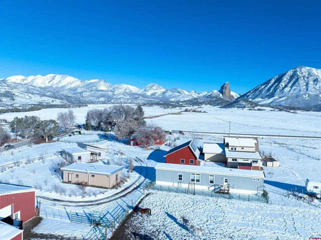 a view of a chairs and table in a backyard