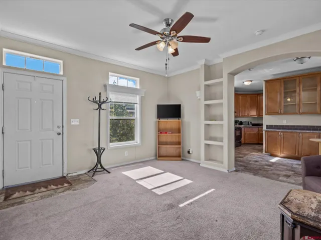 a view of livingroom with hardwood floor and a ceiling fan