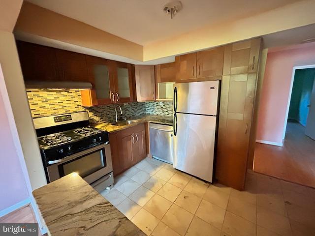 3 Windblown Court, Unit 102 Baltimore, MD 21209 - Photo 13 of 18 a kitchen with stainless steel appliances granite countertop a refrigerator and a stove
