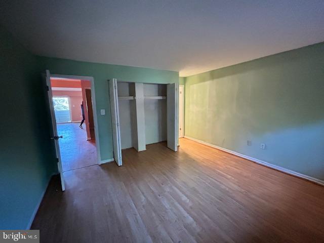3 Windblown Court, Unit 102 Baltimore, MD 21209 - Photo 3 of 18 an empty room with wooden floor and closet