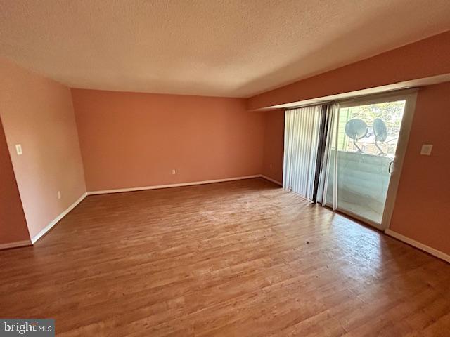 3 Windblown Court, Unit 102 Baltimore, MD 21209 - Photo 8 of 18 an empty room with wooden floor and door