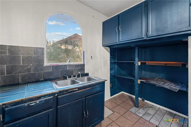 a kitchen with stainless steel appliances granite countertop a sink and cabinets