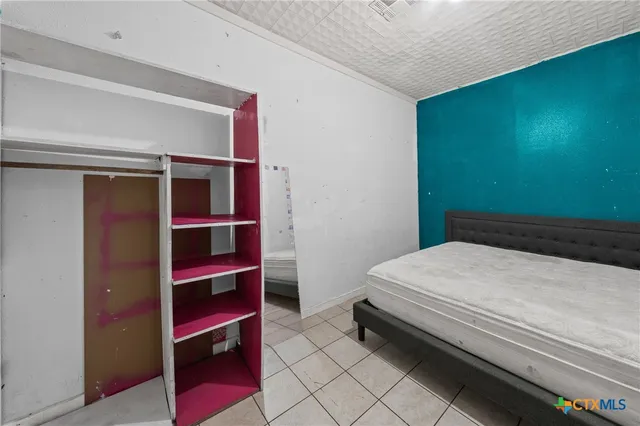 a bedroom with a bed and a closet