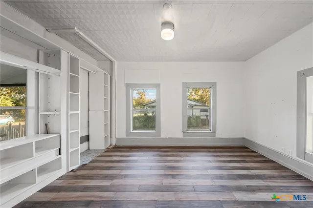 a view of wooden floor and windows in a room
