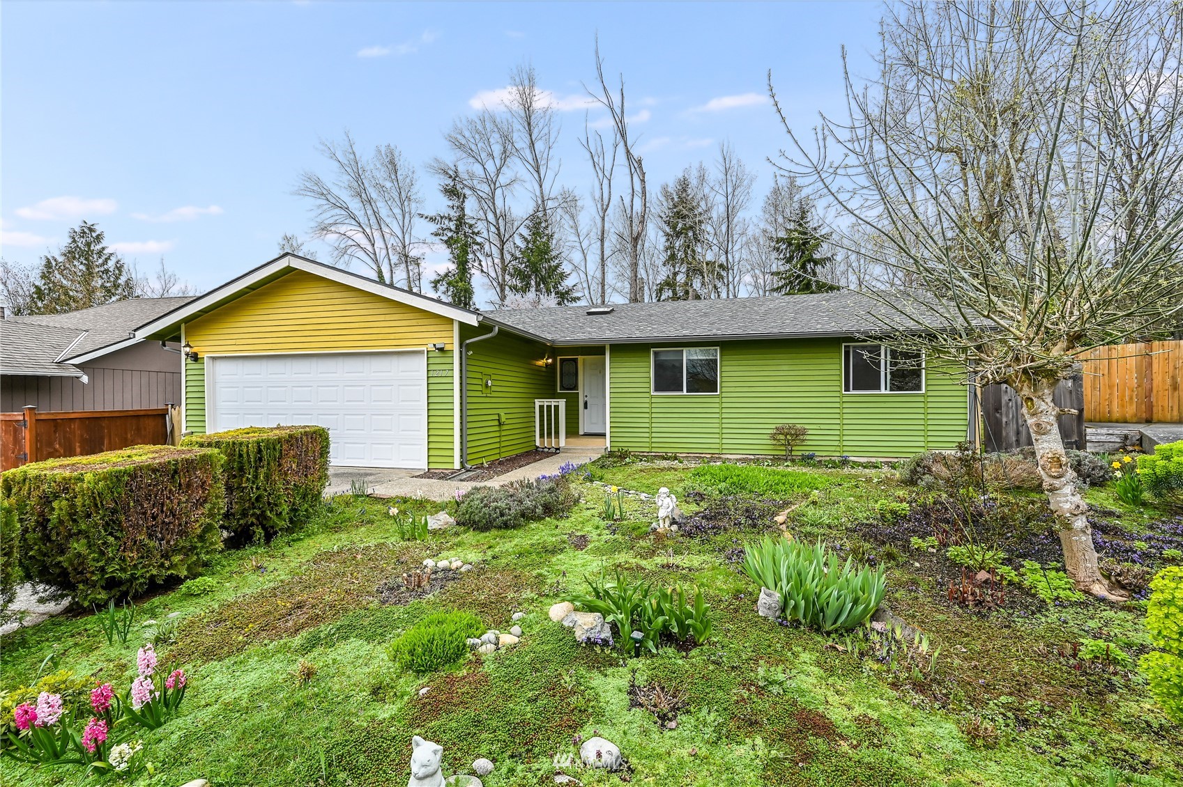 1217 225th Place Southwest Bothell, WA 98021 - Photo 1 of 21 a view of a house with a small yard and plants