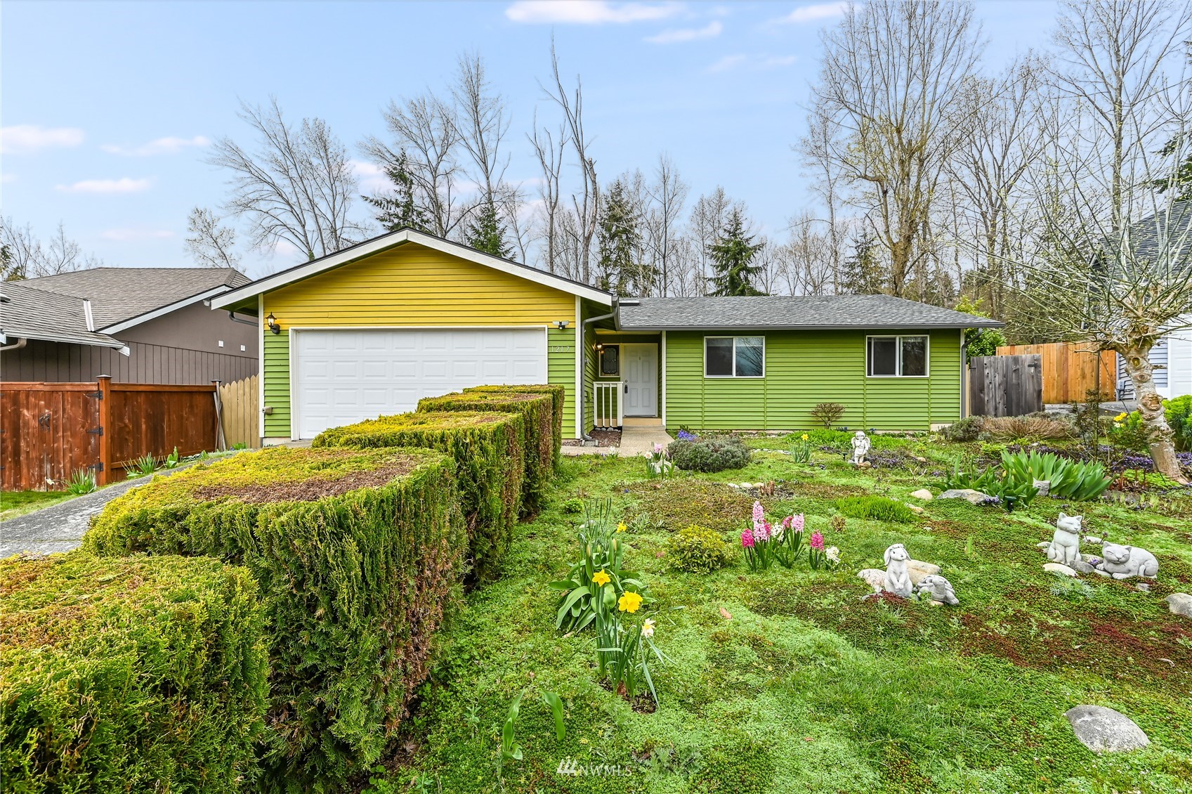 1217 225th Place Southwest Bothell, WA 98021 - Photo 2 of 21 a view of a house with a small yard plants and large tree