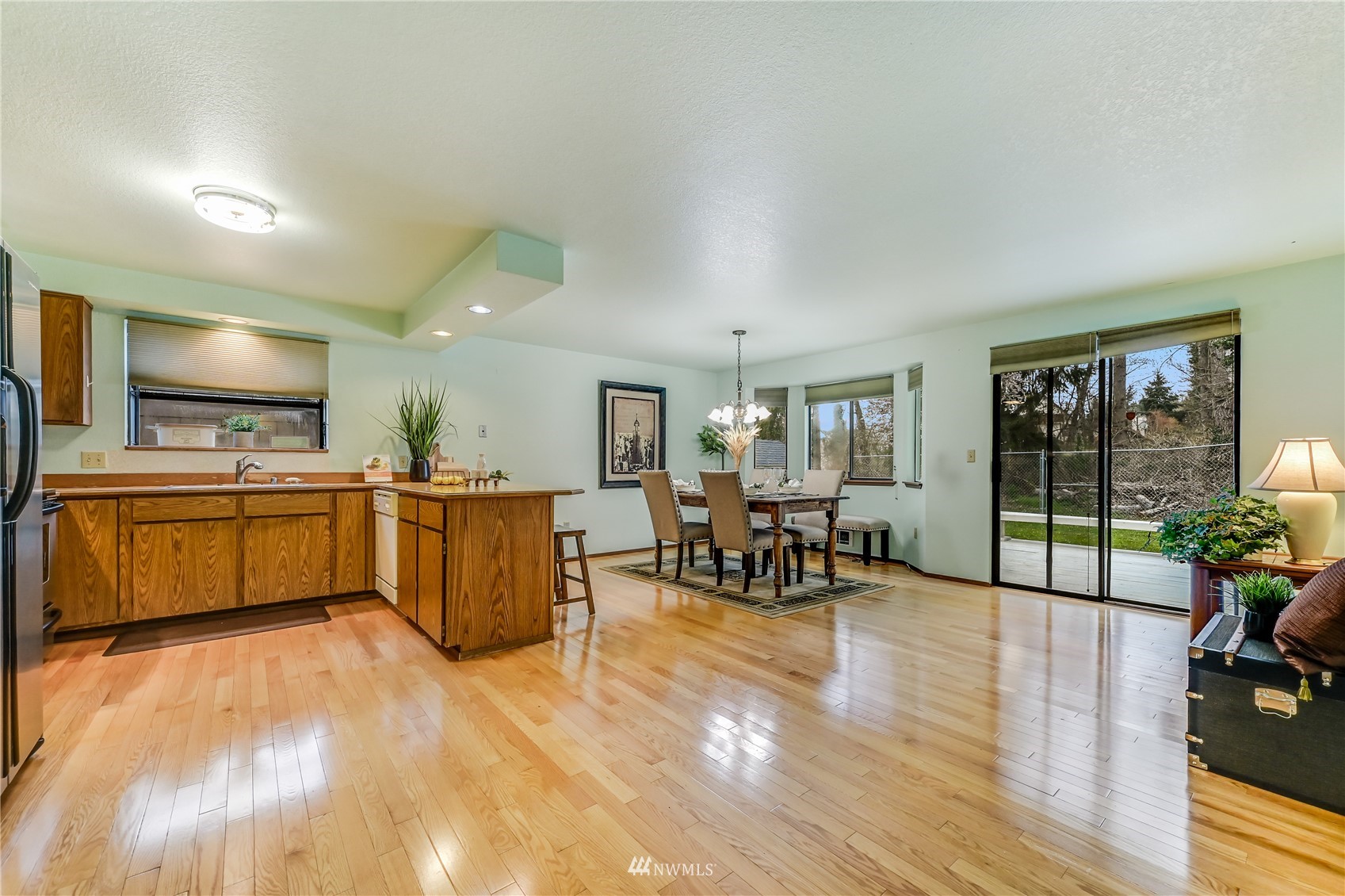 1217 225th Place Southwest Bothell, WA 98021 - Photo 7 of 21 a kitchen with sink cabinets and living room view