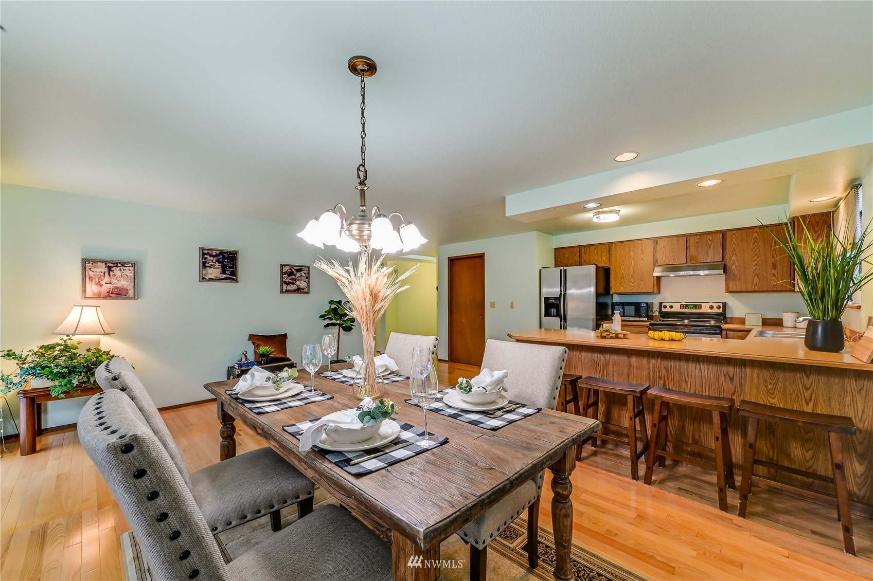 1217 225th Place Southwest Bothell, WA 98021 - Photo 10 of 21 a view of a dining room and livingroom with furniture wooden floor a chandelier