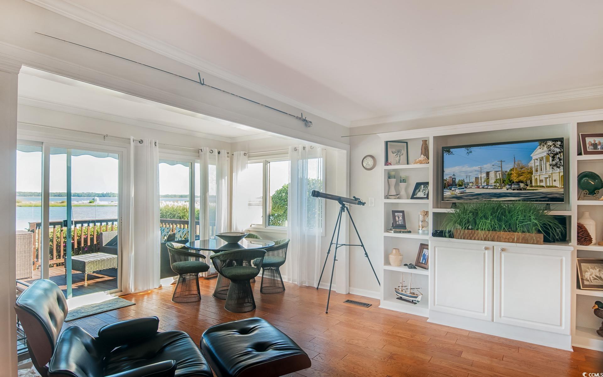 27 Pheasant Loop, Unit 293 Georgetown, SC 29440 - Photo 11 of 23 Living area featuring light wood-type flooring, crown molding, and a water view