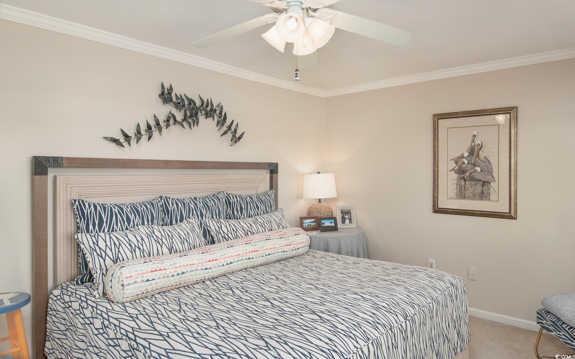 27 Pheasant Loop, Unit 293 Georgetown, SC 29440 - Photo 18 of 23 Carpeted bedroom with crown molding and ceiling fan
