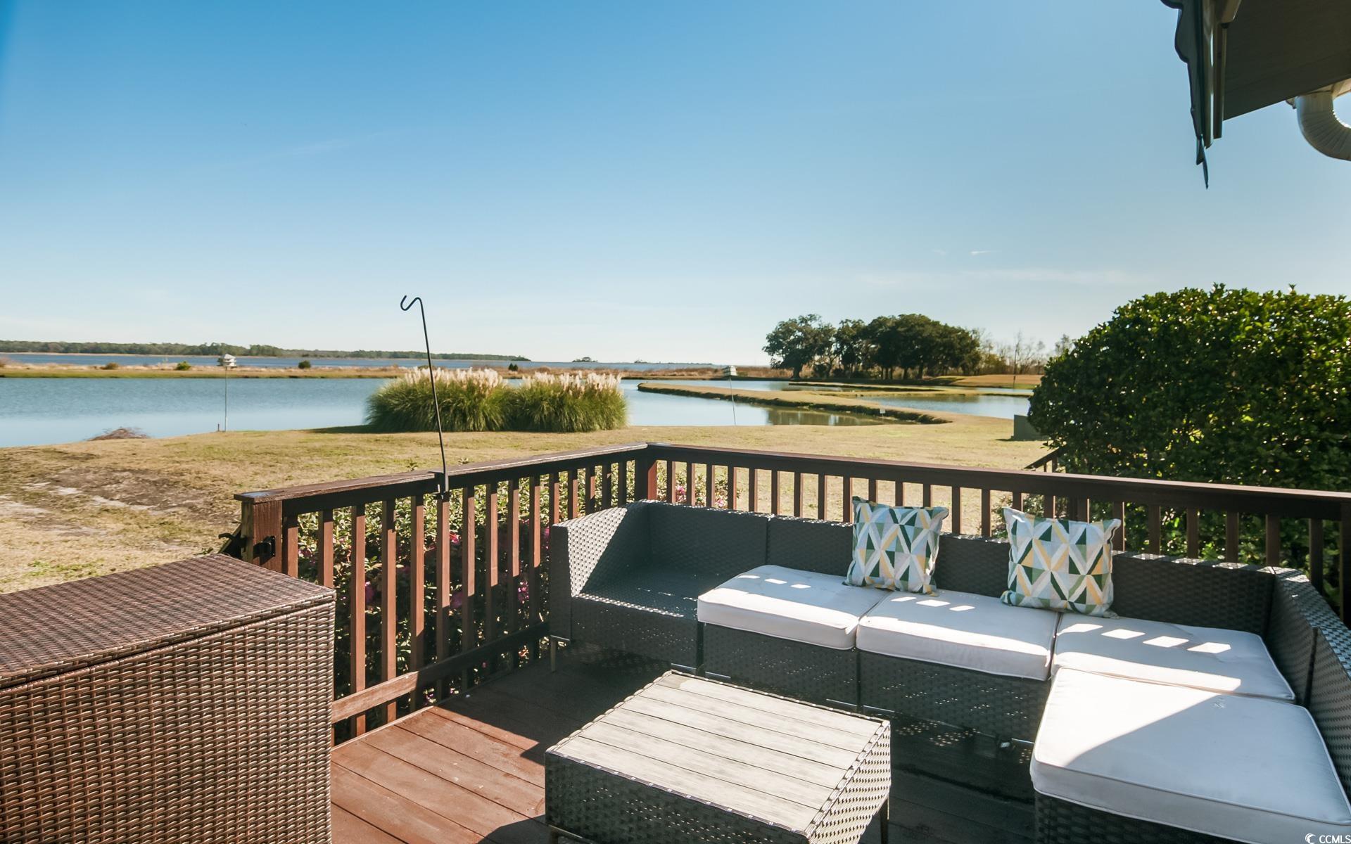 27 Pheasant Loop, Unit 293 Georgetown, SC 29440 - Photo 21 of 23 Wooden deck featuring an outdoor hangout area and a water view