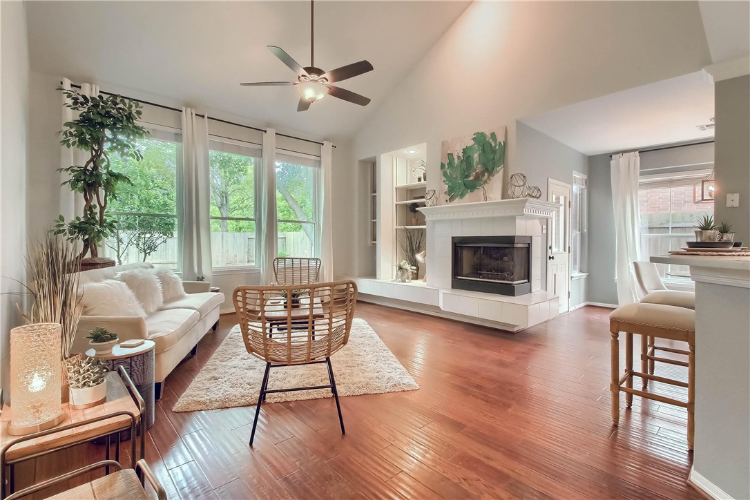 2128 Rodeo Drive Austin, TX 78727 - Photo 1 of 1 a living room with furniture a fireplace and a large window