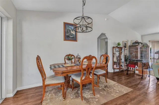 a dining room with furniture and wooden floor