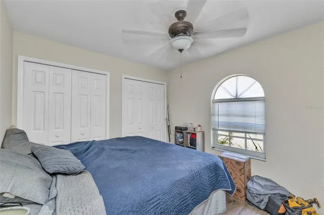 a spacious bedroom with a bed and a large window