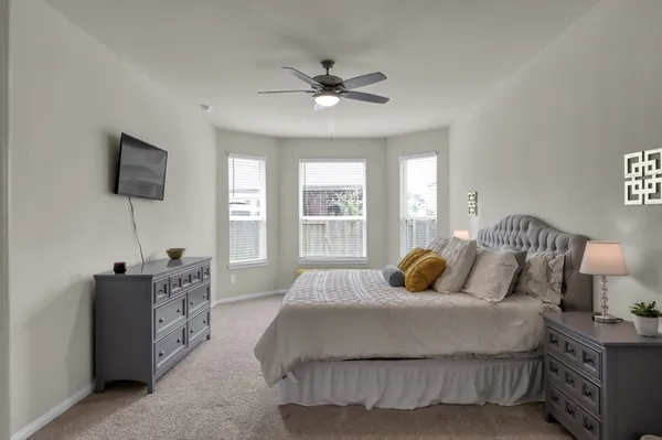 a bedroom with a bed and a flat screen tv