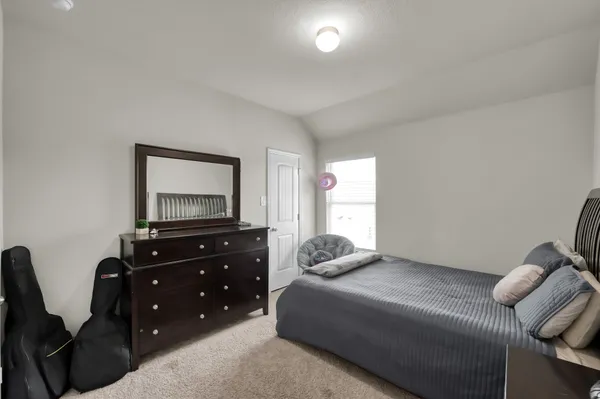 a view of a backyard with table and chairs and wooden fence