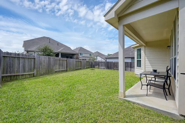 a view of a house with a backyard and porch