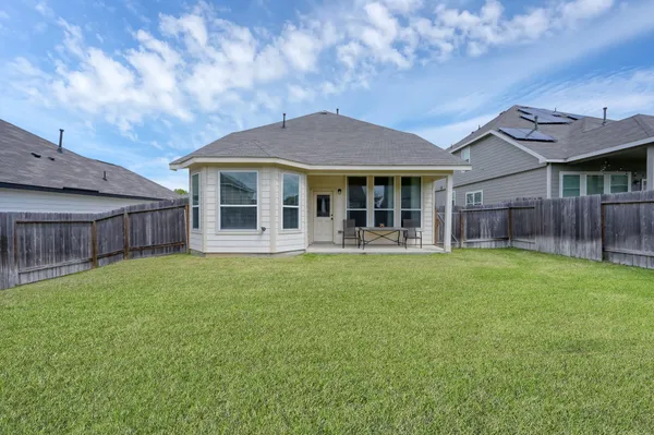 an aerial view of a house with a garden and lake view