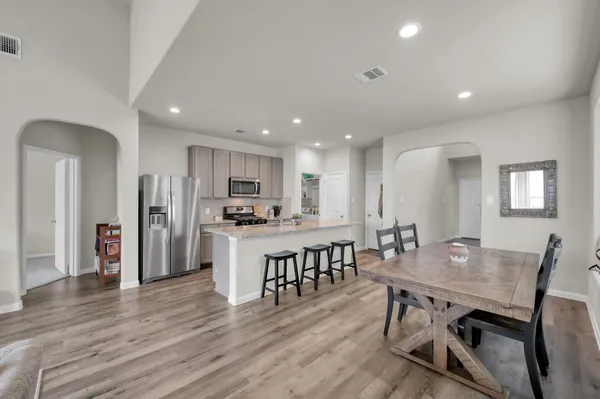 a kitchen with sink refrigerator and cabinets
