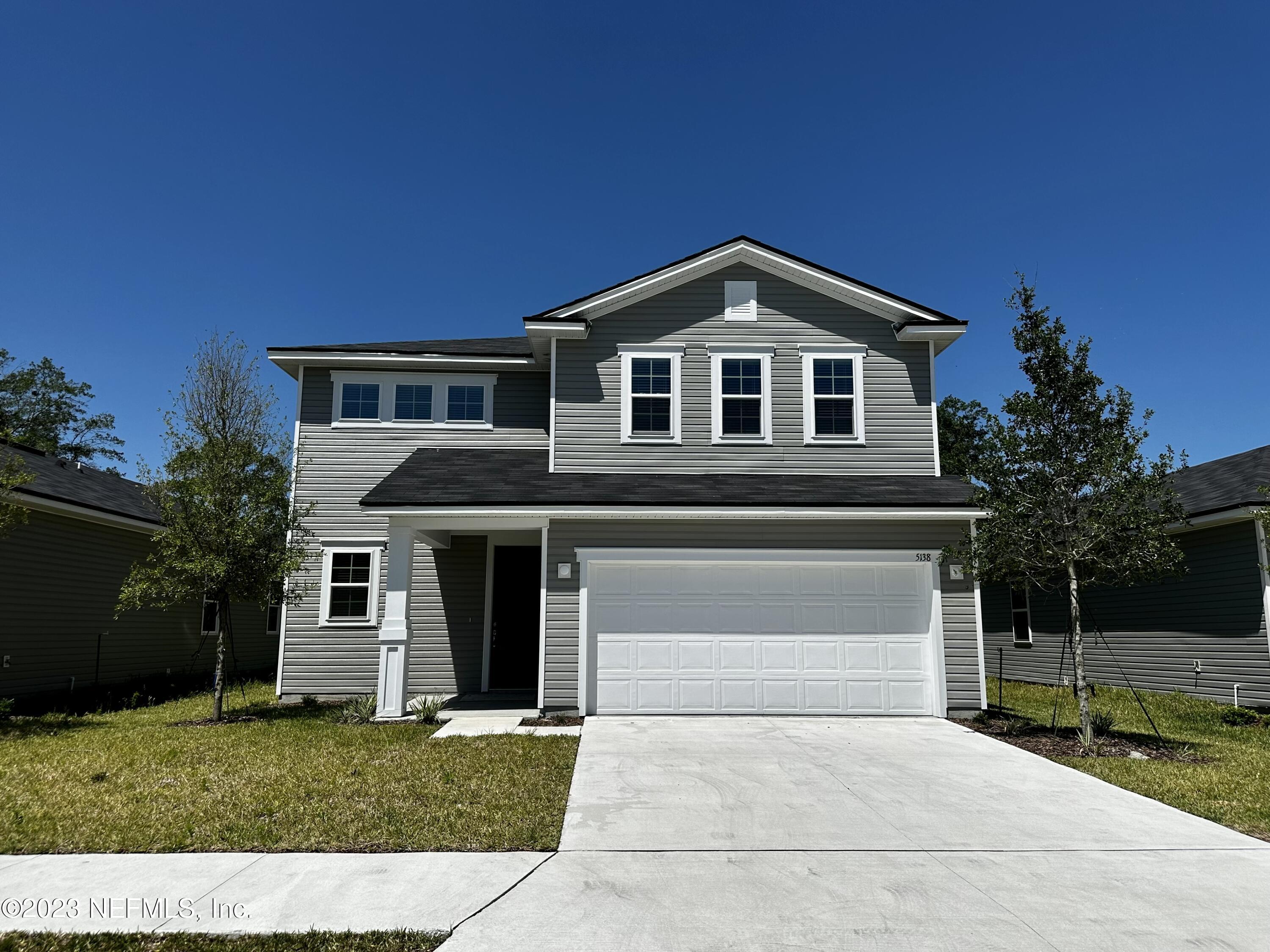 5138 Sawmill Point Way Jacksonville, FL 32210 - Photo 3 of 5 a front view of a house with a yard