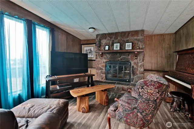 a living room with furniture a flat screen tv and a fireplace