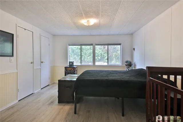 a bedroom with a bed and a window