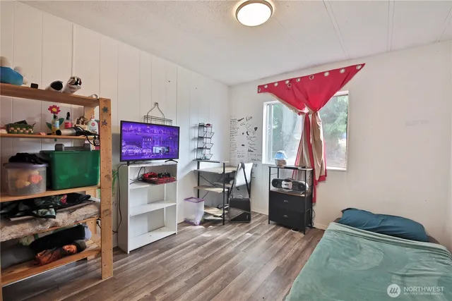 a view of a workspace with furniture and a flat screen tv